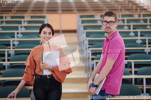 Image of man and woman students posing in school calssroom