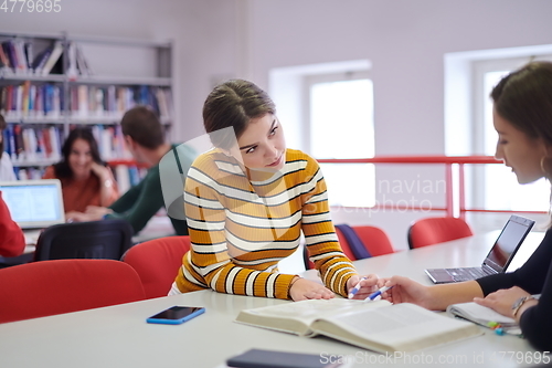 Image of students group working on school project together on tablet computer at modern university