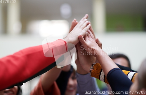 Image of students together in problem, arm in the air