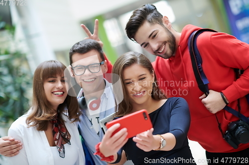 Image of Group of multiethnic teenagers taking a selfie in school