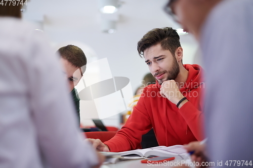 Image of students group working on school project together on tablet computer at modern university