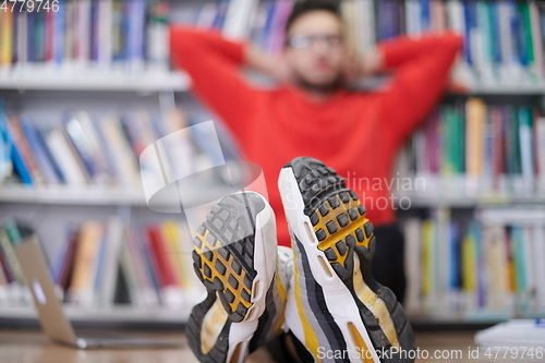 Image of the students uses a notebook, laptop and a school library