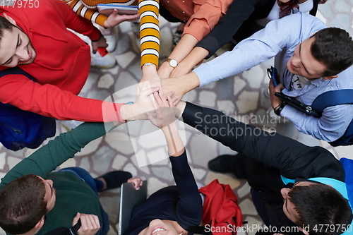 Image of group of happy young people showing their unity.
