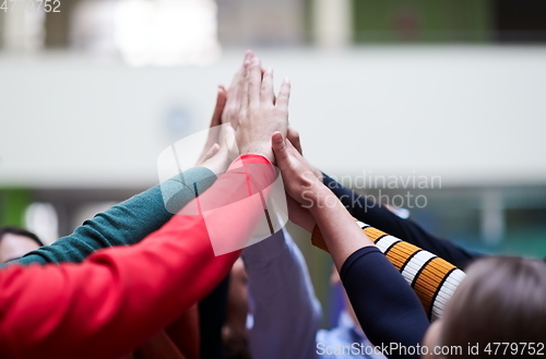 Image of students together in problem, arm in the air