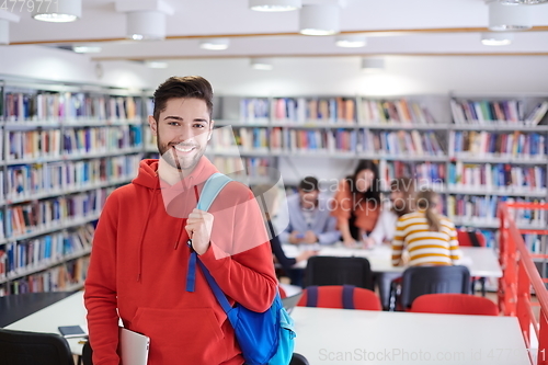 Image of the student uses a laptop and a school library