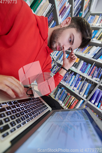 Image of the students uses a notebook, laptop and a school library