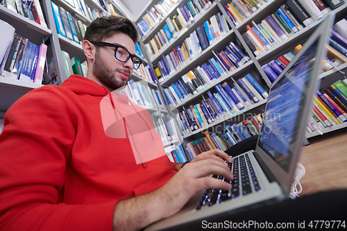 Image of the students uses a notebook, laptop and a school library