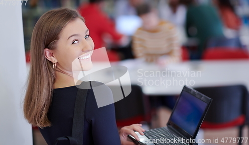 Image of the student uses a notebook and a school library