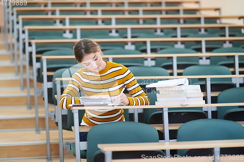 Image of student taking notes for school class