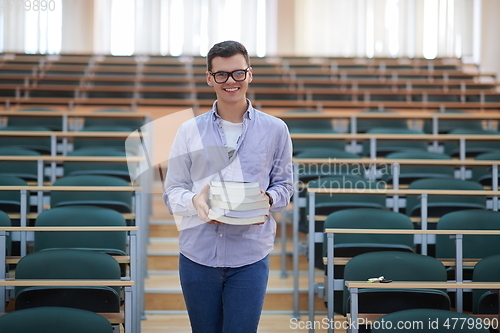 Image of man with book in calssroom