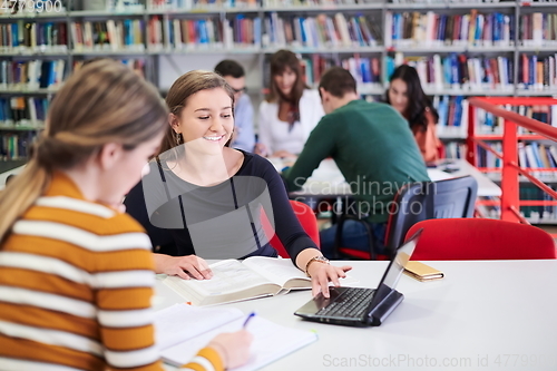 Image of the student uses a notebook and a school library