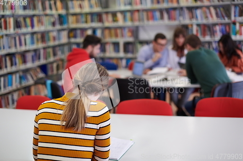 Image of student taking notes for school class