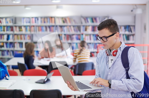 Image of the student uses a notebook, latop and a school library