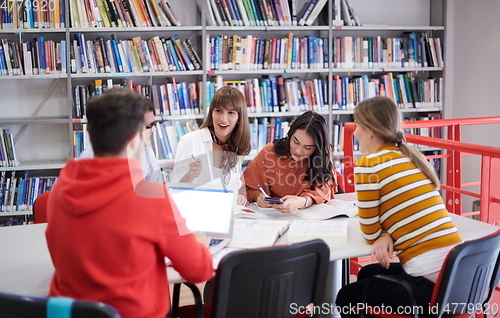 Image of students group working on school project together on tablet computer at modern university