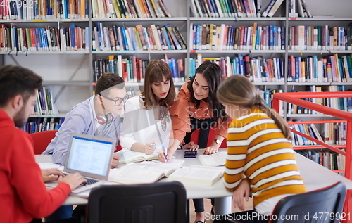 Image of students group working on school project together on tablet computer at modern university