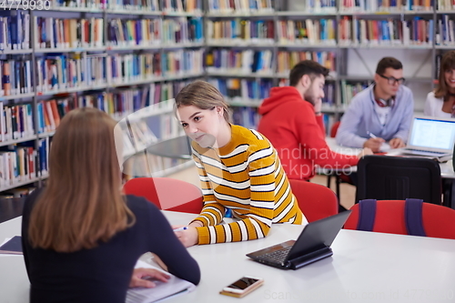 Image of students group working on school project together on tablet computer at modern university