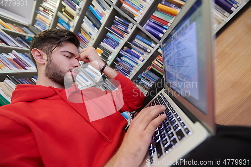 Image of the students uses a notebook, laptop and a school library