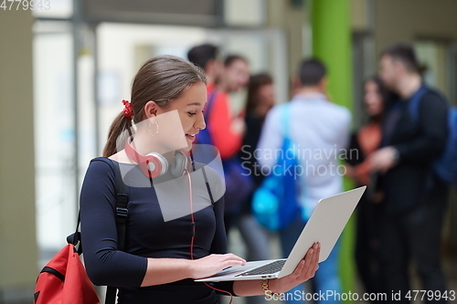 Image of famel student with modern technology in school