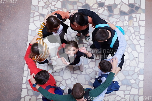 Image of group of happy young people showing their unity.