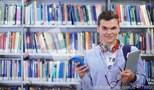 Image of the student uses a notebook, latop and a school library