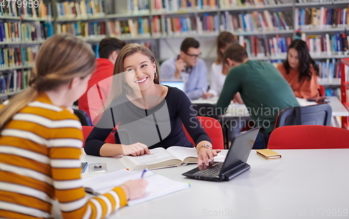 Image of the student uses a notebook and a school library