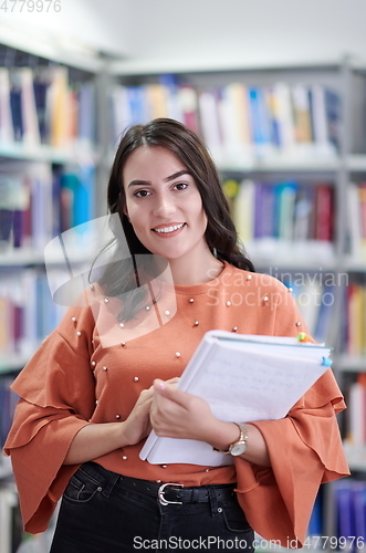 Image of the student uses a notebook and a school library