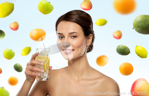 Image of woman drinking water with lemon and ice