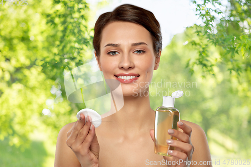 Image of young woman with toner or cleanser and cotton pad