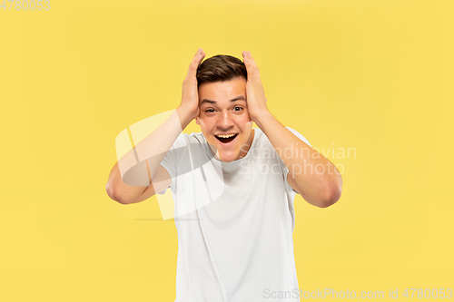 Image of Caucasian young man\'s half-length portrait on yellow background