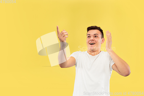 Image of Caucasian young man\'s half-length portrait on yellow background