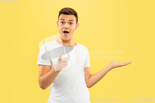 Image of Caucasian young man\'s half-length portrait on yellow background