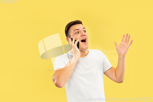 Image of Caucasian young man\'s half-length portrait on yellow background