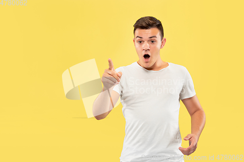 Image of Caucasian young man\'s half-length portrait on yellow background