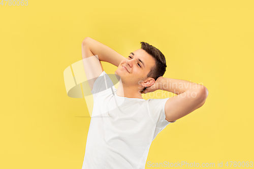 Image of Caucasian young man\'s half-length portrait on yellow background
