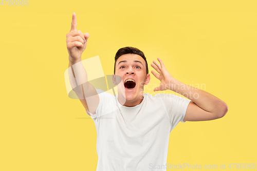 Image of Caucasian young man\'s half-length portrait on yellow background