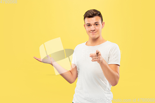Image of Caucasian young man\'s half-length portrait on yellow background