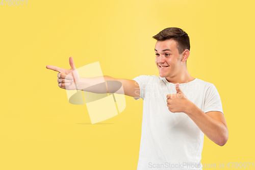 Image of Caucasian young man\'s half-length portrait on yellow background