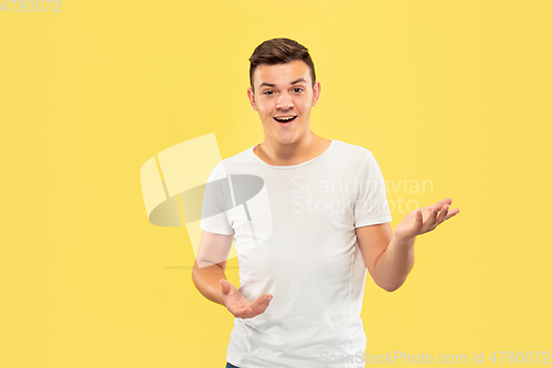 Image of Caucasian young man\'s half-length portrait on yellow background