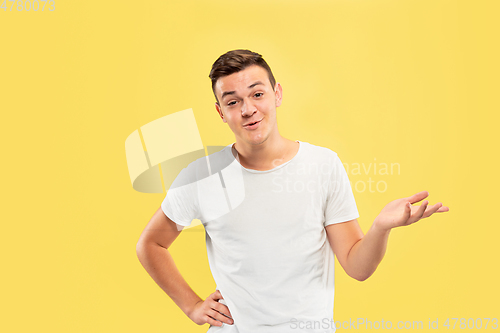 Image of Caucasian young man\'s half-length portrait on yellow background