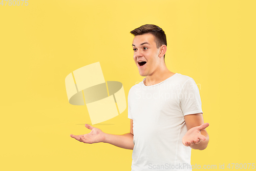 Image of Caucasian young man\'s half-length portrait on yellow background