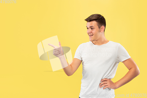 Image of Caucasian young man\'s half-length portrait on yellow background