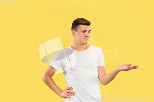 Image of Caucasian young man\'s half-length portrait on yellow background