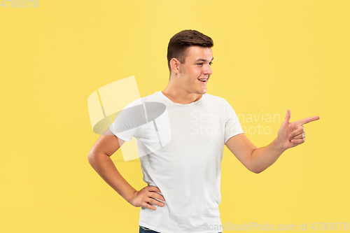 Image of Caucasian young man\'s half-length portrait on yellow background