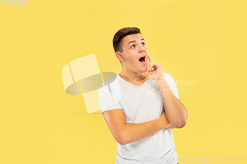 Image of Caucasian young man\'s half-length portrait on yellow background