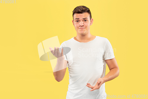 Image of Caucasian young man\'s half-length portrait on yellow background