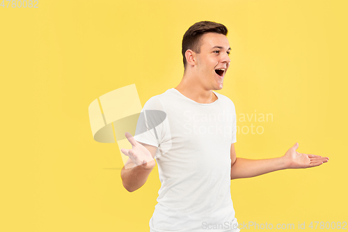 Image of Caucasian young man\'s half-length portrait on yellow background