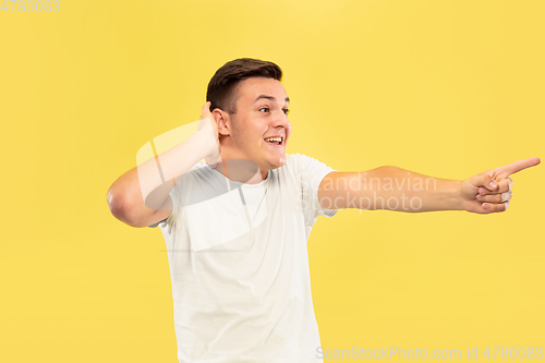 Image of Caucasian young man\'s half-length portrait on yellow background