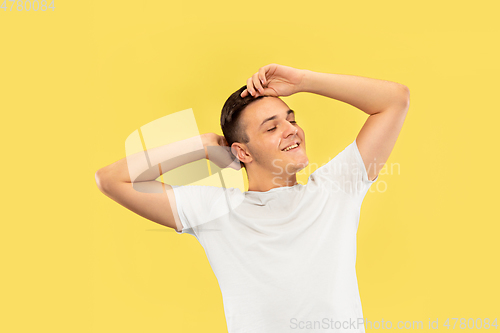 Image of Caucasian young man\'s half-length portrait on yellow background