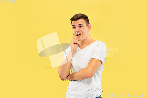 Image of Caucasian young man\'s half-length portrait on yellow background