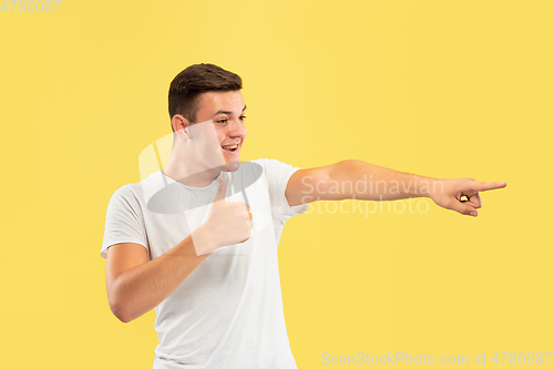Image of Caucasian young man\'s half-length portrait on yellow background